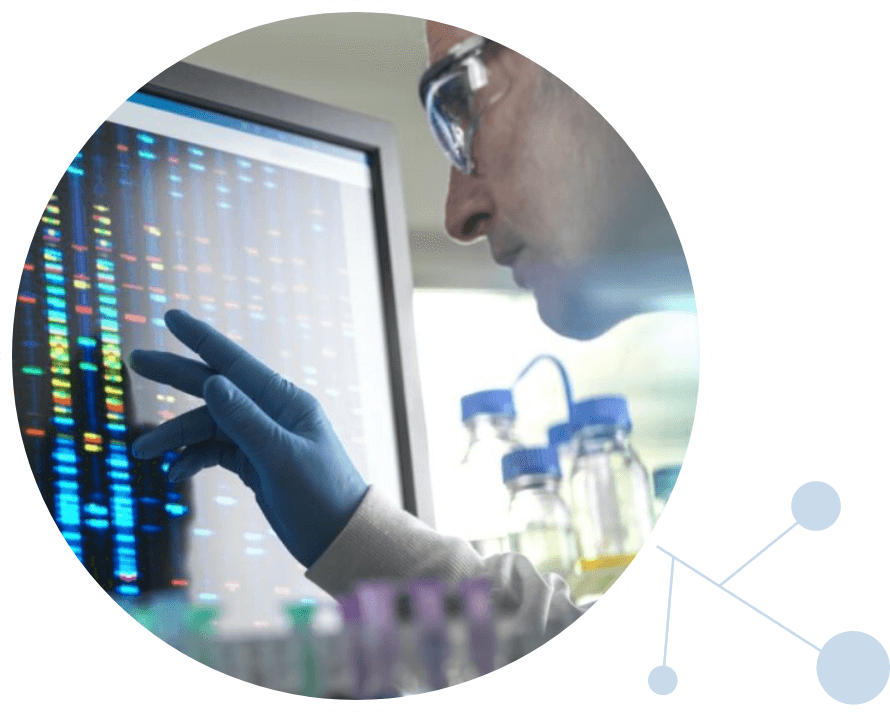 Male scientist looking at DNA data on a screen