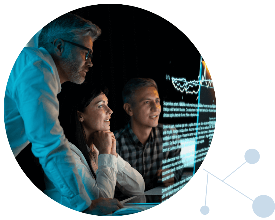 Three people looking at oncology data on a screen